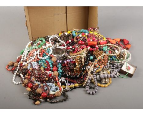 A box of costume jewellery. Includes beads, bangle, earrings, ring etc.  