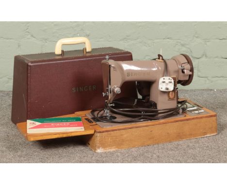 A cased Singer 185k sewing machine, with key and instruction manual.  