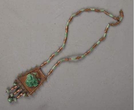A Mexican carved jade and gilt metal necklace and pendant.  