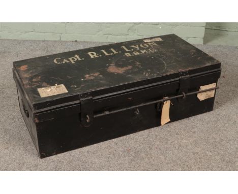 A military Royal Army Medical Core black painted tin trunk stenciled for Capt. R. Li. Lyon (R.A.M.C) to top.  