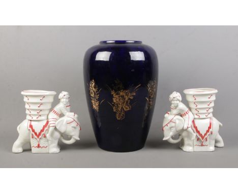 A pair of Art Deco style ceramic elephant figurines together with a large continental cobalt blue vase. Height of elephants: 