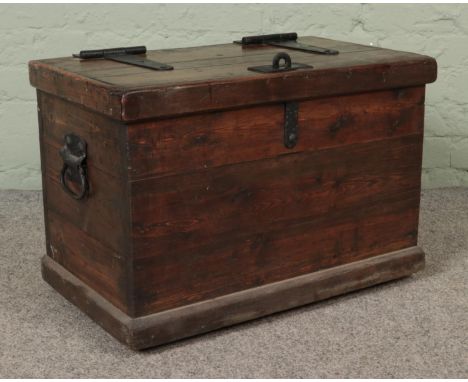A pine trunk with hasp lock lid and cast iron handles.Hx44cmWx64cmDx37cm  