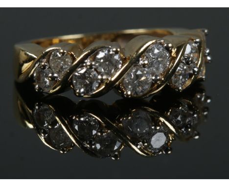 An 18ct Gold and ten stone diamond ring, with the stones set in a rope twist setting. Size K. Total weight: 5.0g.  