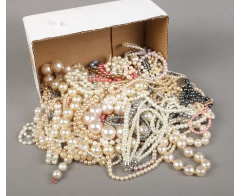 A box of simulated pearl necklaces and bracelets.  
