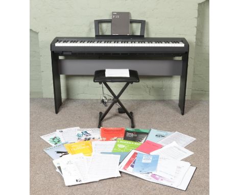 A Yamaha P-35 Digital Piano, on stand with stool, with additional LP5A foot pedal. Complete with instruction manual, original