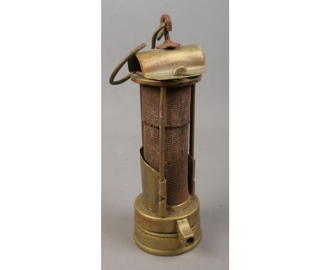 A brass miners Davy lamp, Stamped JM to the top. Possible mark for J.Ullathorn.  