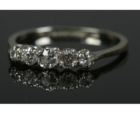 A platinum five stone diamond ring. Size N, 1.8g.  