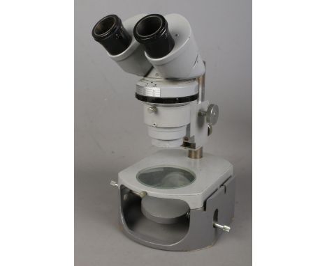 A Nikon binocular microscope No. 73026.  Appears to be in working order. No signs of damage.