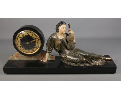 A large Art Nouveau style slate figural mantel clock. Formed as a seated maiden holding a violin. (30cm x 72cm)  Pendulum pre