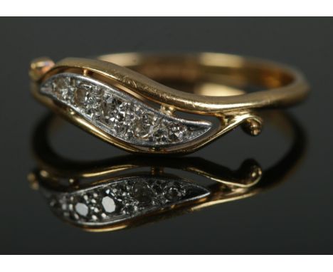 An 18ct gold and scroll set five stone diamond ring. Size NÂ½, 2.3g.  