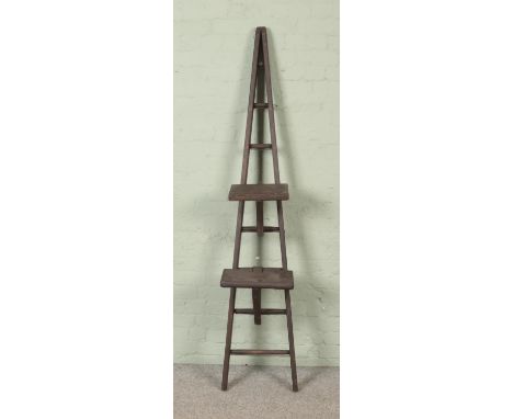 A painted seven rung wooden A-Frame ladder, possibly for fruit picking, with two platform steps. Height: 202cm.  