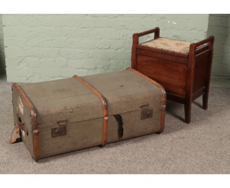 A vintage wood bound travel trunk along with a mahogany stool.  