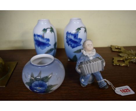 A pair of Royal Copenhagen vases, each painted with a flower, 14cm high; together with another similar smaller ovoid example;