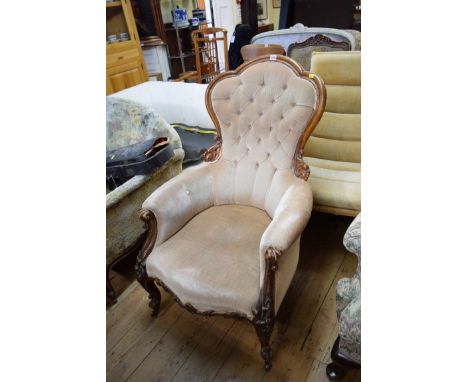 A Victorian carved walnut and button upholstered occasional armchair. 