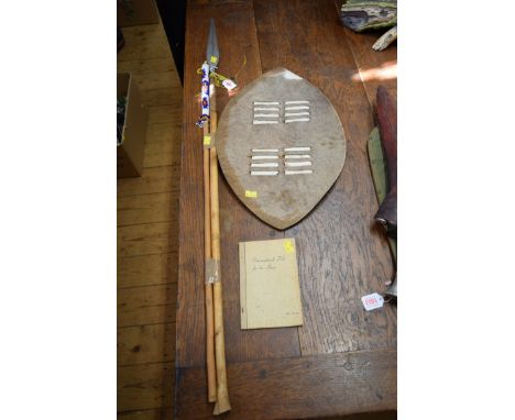 Ethnographica: a Zulu spear; together with another similar beadwork applied staff; a zebra hide shield; and a copy of 'Conver