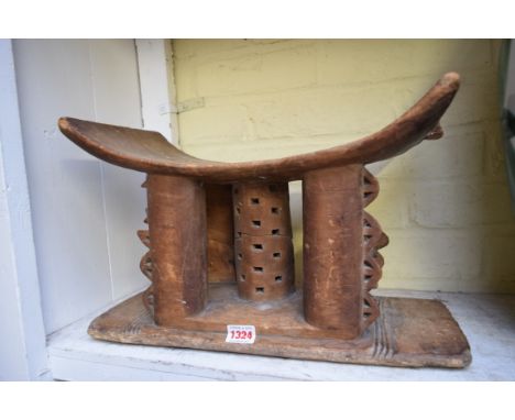 Ethnographica: a tribal carved wood headrest, 42cm wide.