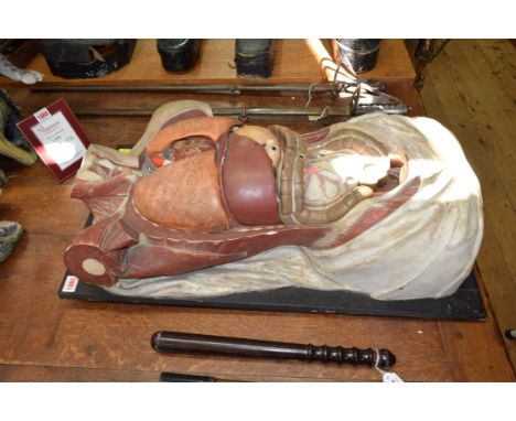 An antique anatomical torso model, with removable organs, on ebonized mount with easel back, length of mount 75cm. 
