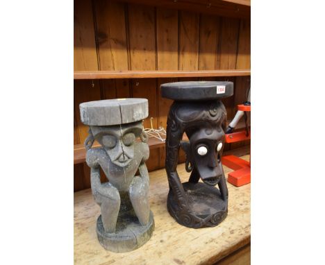 Ethnographica: two carved hardwood tribal stools, one with shell inset eyes, largest 50.5cm high. 