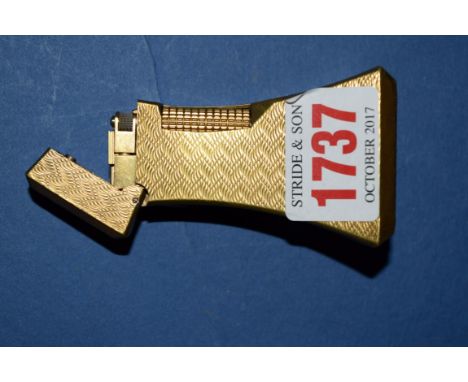A Dunhill gilt engine turned lighter, 7.5cm high. 