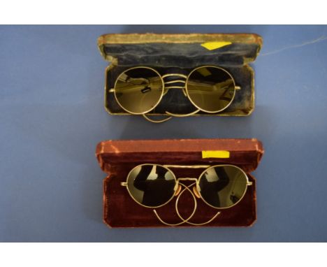A cased pair of World War II military sunglasses, one arm inscribed 'AM MkVIII 22C/96?', the case inscribed with broad arrow 