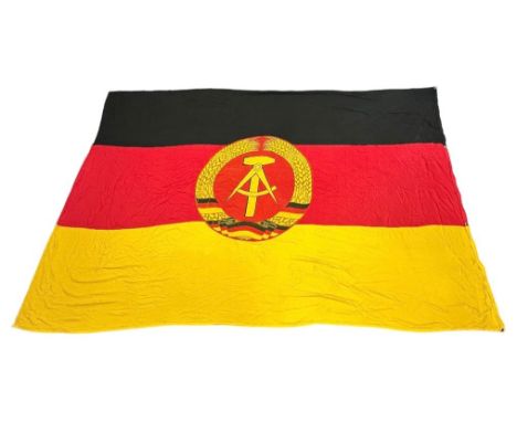 East Germany, extremely large East Germany fabric flag, stitched design with attached round insignia. The flag features a coa