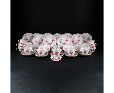 A Meissen white and deep pink porcelain part of a tea service comprising 12 tea cups and saucer, 11 cake plates and 1 small b