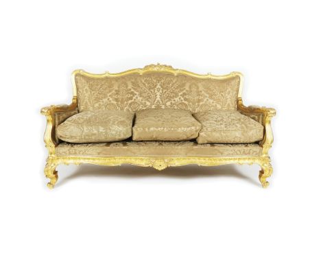 A carved gilt wood sitting service, 19th century comprising a sofa, a pair of armchairs, 4 chairs, a pair of stools, a sofa m