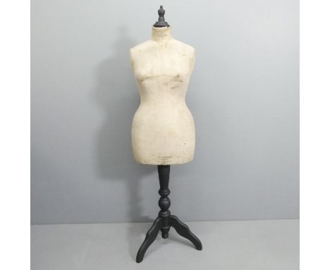A Stockman's dressmaker's mannequin on ebonised tripod stand. Height 161cm. 