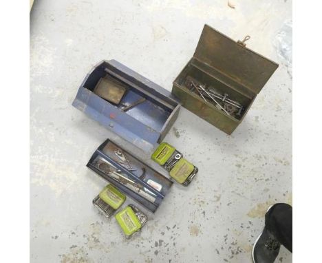 Two metal tool boxes containing various tools, drill bits and punches. 