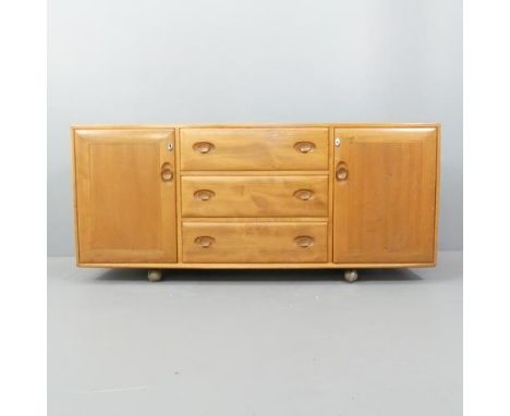 ERCOL - A model 455 Windsor sideboard, with three drawers between two cupboards and maker's mark. 156x69x46cm.Various use rel