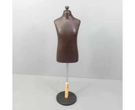 A modern leather covered mannequin on stand, of small male form. Height overall 130cm. 