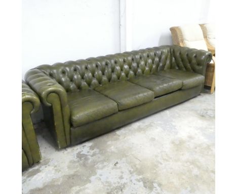 A four-seater green leather upholstered Chesterfield style sofa. Overall 250x70x90, seat 200x39x60cm. 