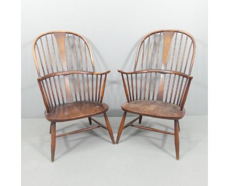 ERCOL - a pair of mid-century Chairmaker's comb-back elbow chairs. With maker's labels. 