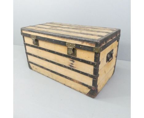 A 19th century French designer pine and metal bound travel trunk, with label for Constant Vuiton. 102x56x56cm.