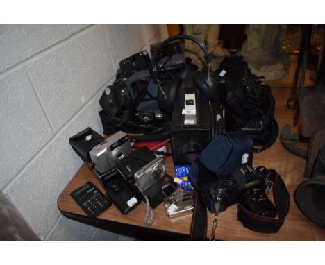 A mixed lot of camera equipment, including Canon, Polaroid, Panasonic camcorder and much more.