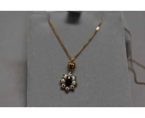 A sapphire and CZ cluster pendant in 9ct gold mount on 9ct gold chain, approx 18" &amp; 2g