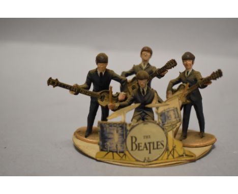An Original 1960's Subbuteo Beatles Figure set, a set of four, with guitars and original card cut out drum kit.