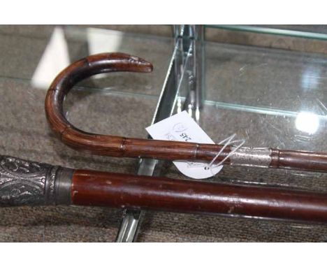 TWO VINTAGE WALKING STICKSone with an Indian silver figured embossed handle