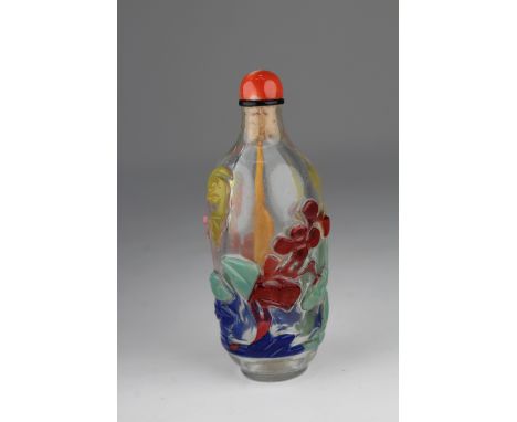 Chinese 5-Color Overlaid Clear Glass Snuff Bottle. The well-formed ovoid bottle decorated in various colors, skillfully carve