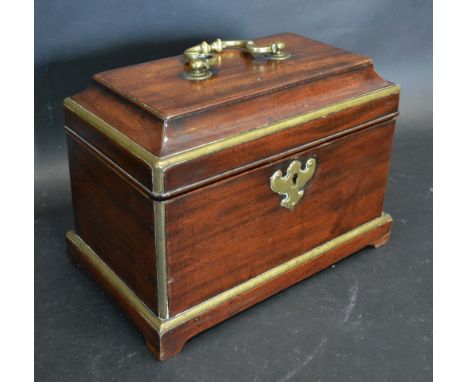 A George III Mahogany Brass Mounted Two Division Tea Caddy, the hinged cover with brass handle and escutcheon raised upon bra