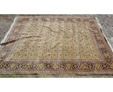 A North West Persian Large Woollen Carpet with an all over design upon a blue and cream ground within multiple borders, 397 x