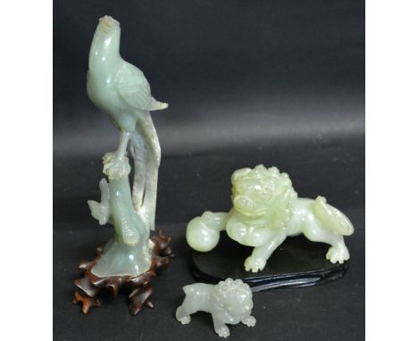 An Early 20th Century Chinese Green Jade Model in the form of a Lion, together with another similar model of an exotic bird a