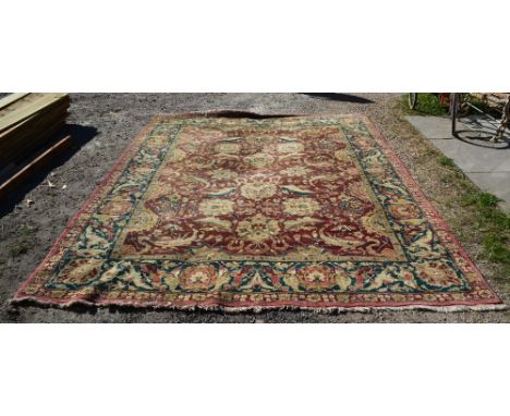 A North West Persian Woollen Carpet with an all over design upon a terracotta and blue ground within multiple borders, 360 x 