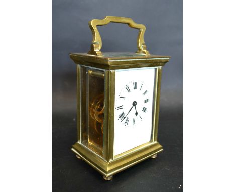 A French Brass Cased Carriage Clock, the enamel dial with Roman numerals and with lever escapement and brass carrying handle