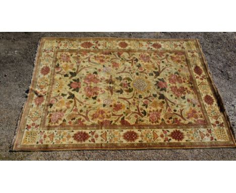 A North West Persian Woollen Carpet with an all over design upon a cream ground within multiple borders, 370 x 272 cms