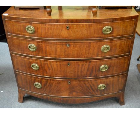 A Regency bow front chest raised on splayed legs 