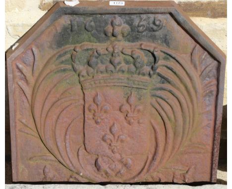 A cast iron fire back, shallow stone trough and a pair of red painted cast iron urns (4)