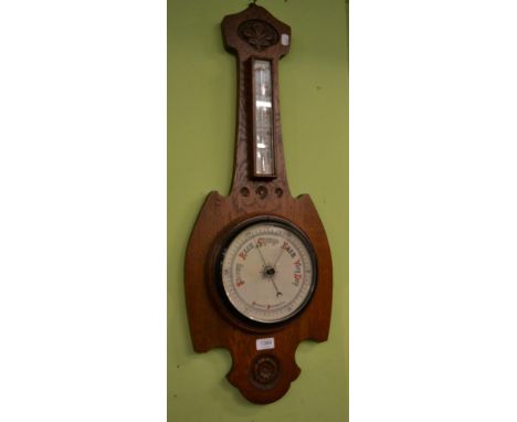An early 20th century carved oak aneroid barometer 