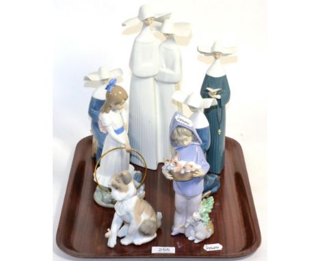 Six Lladro figures comprising; four nuns, a young girl holding a cat basket, a dog, and a Nao figure of a young girl and a do