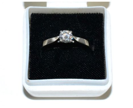 A platinum solitaire diamond ring, a round brilliant cut diamond in a claw setting, to knife edge shoulders, estimated diamon